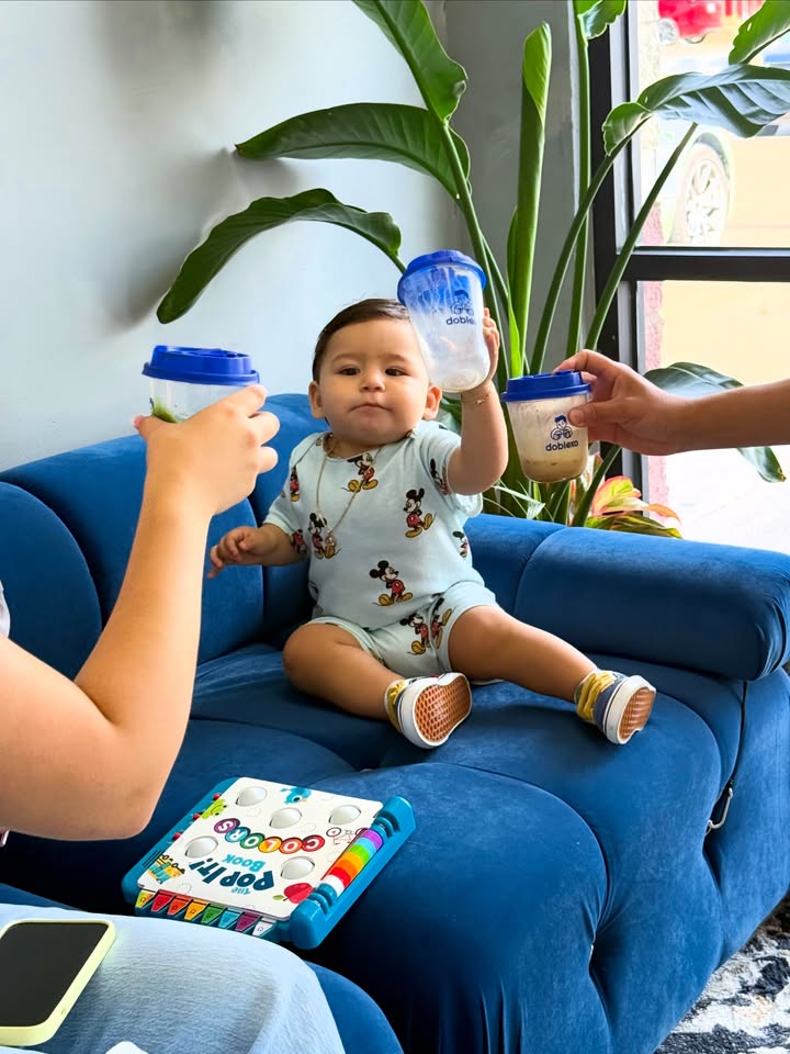 Happy baby with branded drink cup